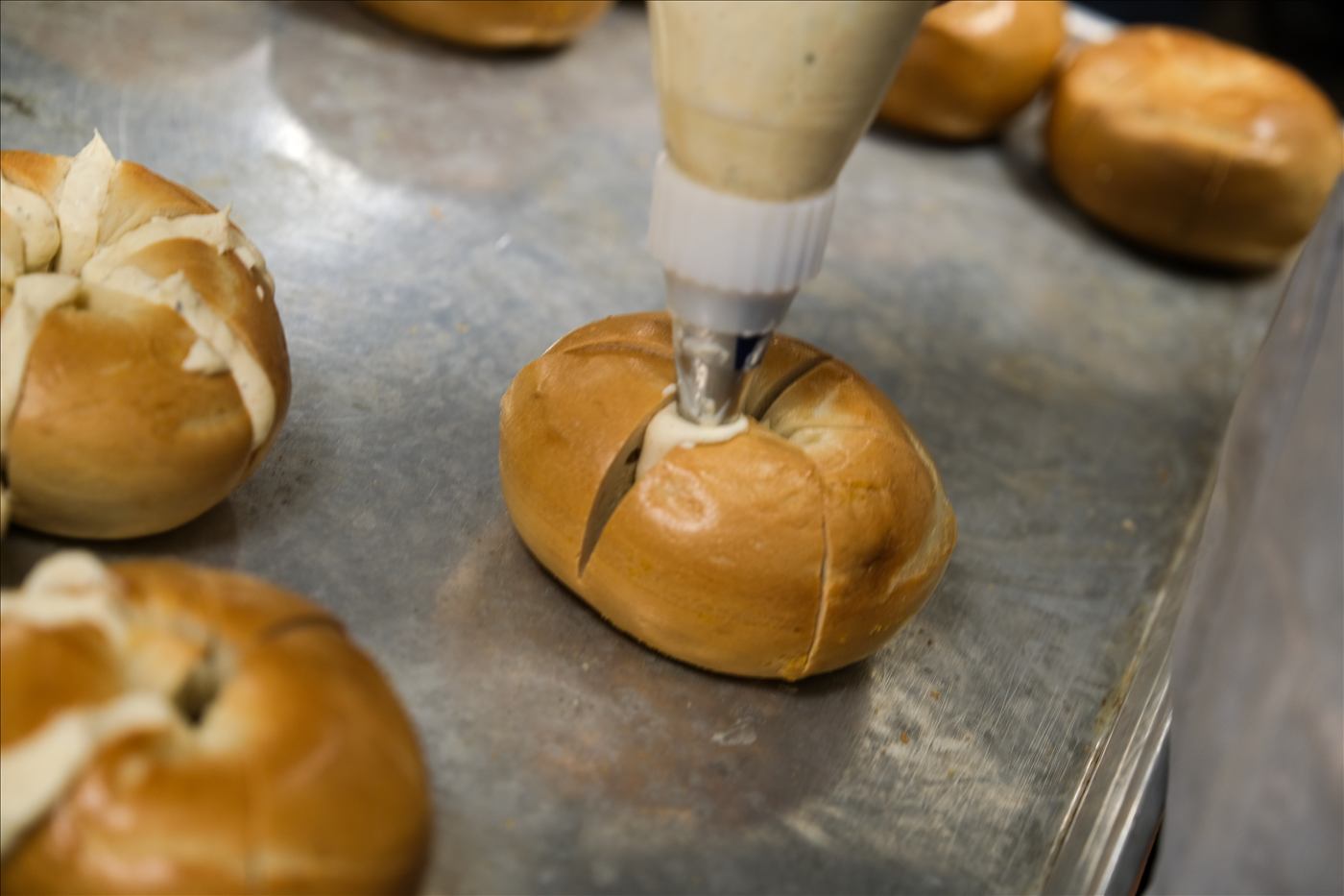 Filling bagels by hand