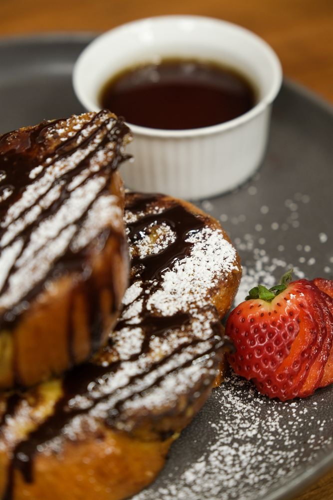 French Toast Brûlée with strawberries and maple syrup